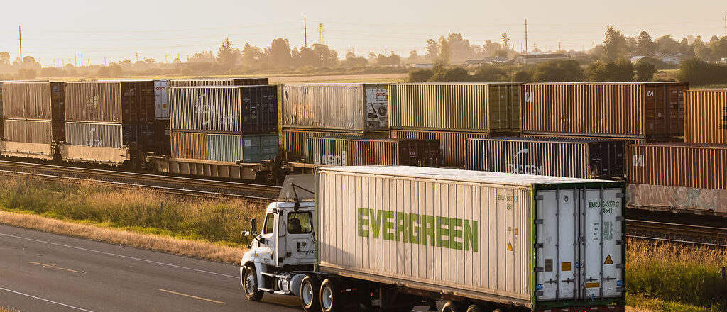 Sandhar Trucking is a leading provider for container drayage services. A truck is pulling a container along Deltaport way to drop off at the Port.