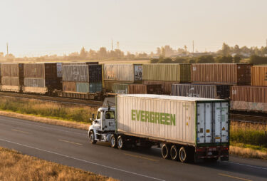 Sandhar Trucking is a leading provider for container drayage services. A truck is pulling a container along Deltaport way to drop off at the Port.